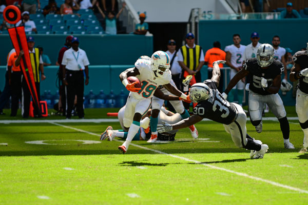 Miami Dolphins wide receiver Jakeem Grant (19) stiff arms Oakland Raiders running back Jalen Richard (30)