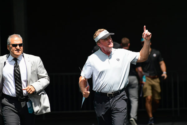 Oakland Raiders head coach Jon Gruden points to the fans as he runs out to the field