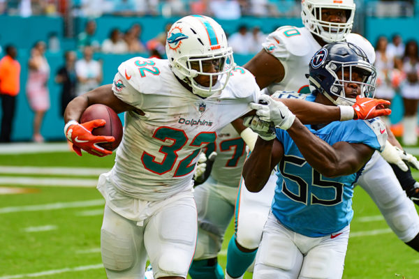 Miami Dolphins running back Kenyan Drake (32) with the stiff arm on Tennessee Titans linebacker Jayon Brown (55)