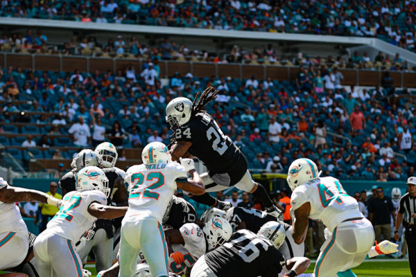 Oakland Raiders running back Marshawn Lynch (24) leaps over the pile