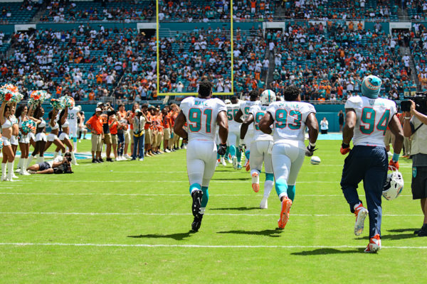 Miami Dolphins defensive end Cameron Wake (91) runs onto the field with his teammates