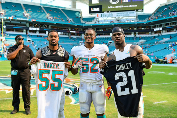 Miami Dolphins linebacker Jerome Baker (55), Miami Dolphins linebacker Raekwon McMillan (52) and Oakland Raiders cornerback Gareon Conley (21)