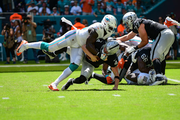 Miami Dolphins defensive end William Hayes (95) sacks Oakland Raiders quarterback Derek Carr (4)