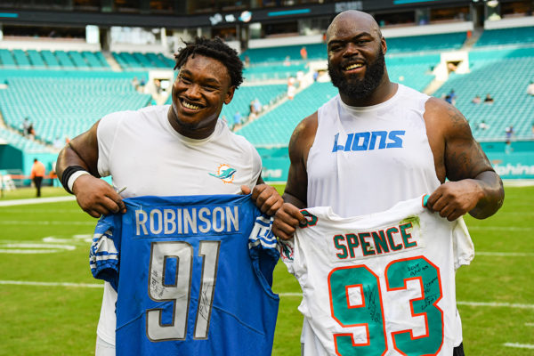 Detroit Lions defensive tackle A'Shawn Robinson (91) and Miami Dolphins defensive tackle Akeem Spence (93) exchange jerseys