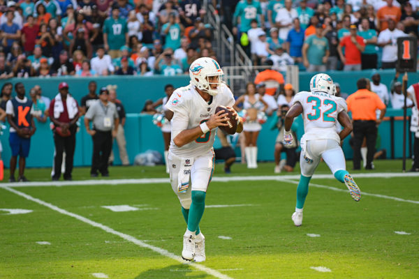 Miami Dolphins quarterback Brock Osweiler (8) rolls out of the pocket