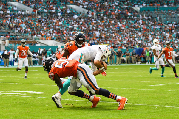 Chicago Bears inside linebacker Danny Trevathan (59) hits Miami Dolphins quarterback Brock Osweiler (8) as he tries for a first down