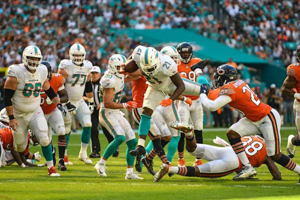 Miami Dolphins running back Frank Gore (21) hurdles a defender