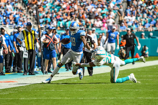 Detroit Lions wide receiver Kenny Golladay (19) with a stiff arm to Miami Dolphins strong safety T.J. McDonald (22)