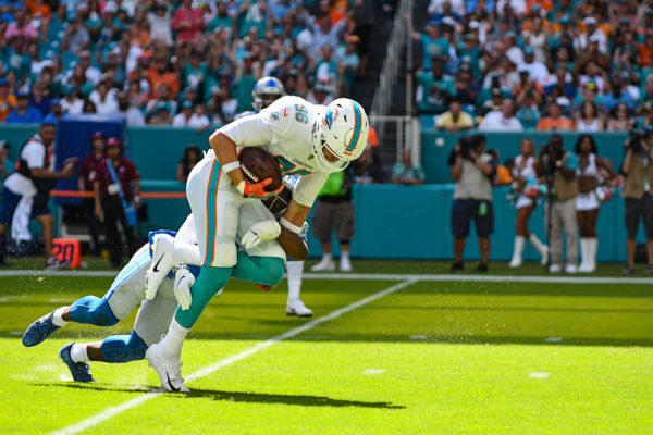 Miami Dolphins tight end Mike Gesicki (86) gets tackled by Detroit Lions strong safety Quandre Diggs (28)