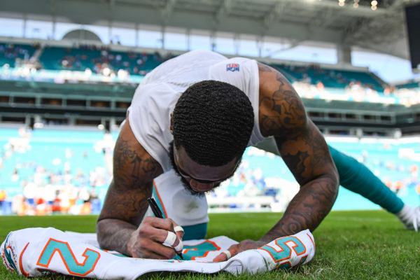 Miami Dolphins cornerback Xavien Howard (25) signs his jersey after the game