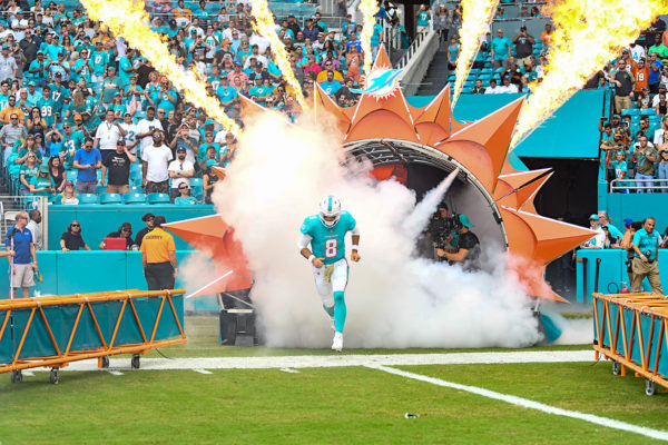 Miami Dolphins quarterback Brock Osweiler (8) runs through the smoke