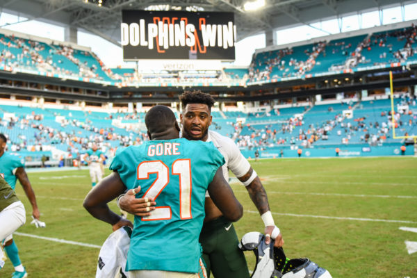 Miami Dolphins running back Frank Gore (21) and New York Jets strong safety Jamal Adams (33) meet after the game