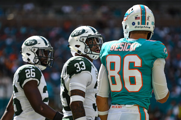 New York Jets strong safety Jamal Adams (33) talks to Miami Dolphins tight end Mike Gesicki (86)