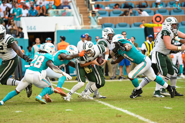 Miami Dolphins defensive end Andre Branch (50) grabs the facemask of New York Jets quarterback Sam Darnold (14)