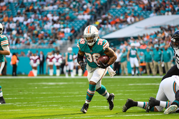 Miami Dolphins running back Brandon Bolden (38) looks for an opening