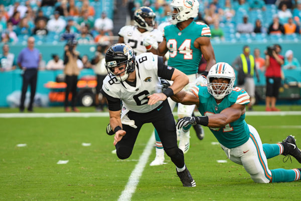 Jacksonville Jaguars quarterback Cody Kessler (6) falls down after contact by Miami Dolphins defensive end Cameron Wake (91)