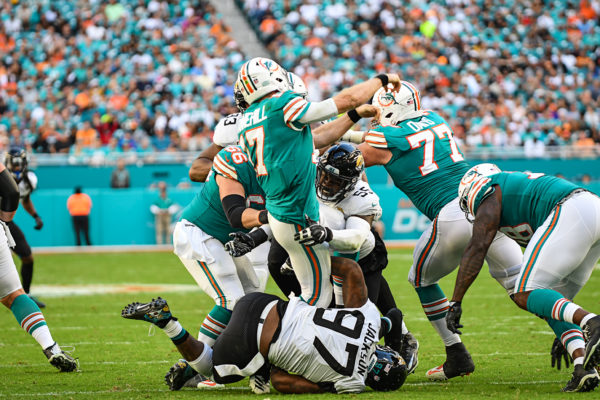 Miami Dolphins quarterback Ryan Tannehill (17) gets hit as he throws