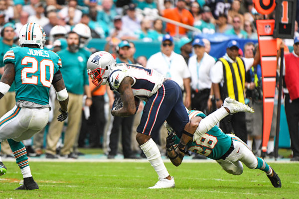 Miami Dolphins cornerback Bobby McCain (28) tackles New England Patriots wide receiver Josh Gordon (10)