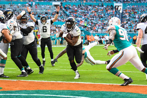 Jacksonville Jaguars quarterback Cody Kessler (6) signals touchdown as Jacksonville Jaguars running back Leonard Fournette (27) rushes in for the score