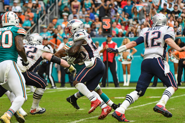 New England Patriots running back Sony Michel (26) takes the hand off from New England Patriots quarterback Tom Brady (12)