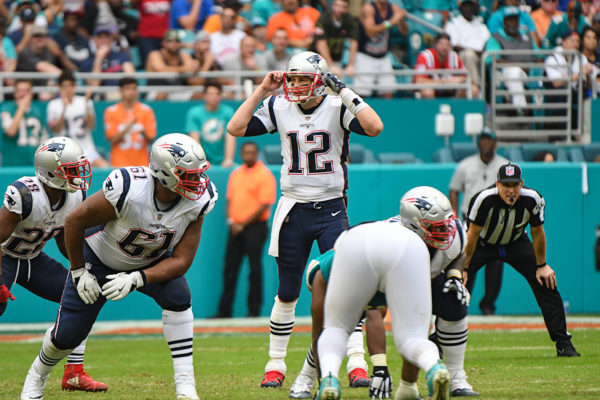 New England Patriots quarterback Tom Brady (12) calls an audible