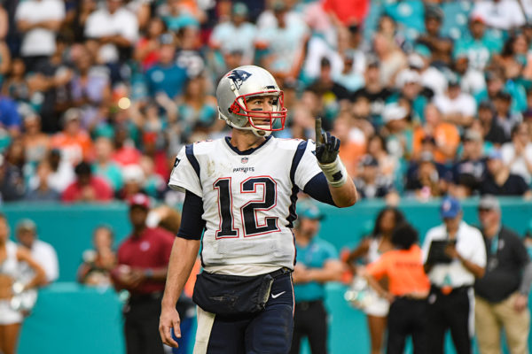 New England Patriots quarterback Tom Brady (12) signals 1 to the bench before a timeout