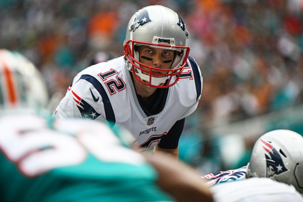 New England Patriots quarterback Tom Brady (12) looks at the defender