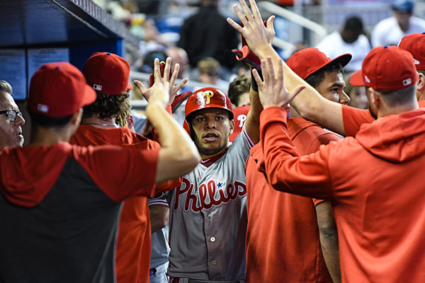 Philadelphia Phillies second baseman Cesar Hernandez (16) gets high-fives from teammates