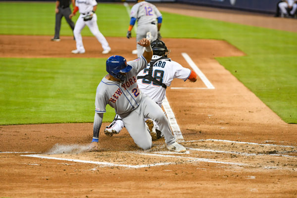 New York Mets first baseman Dominic Smith #22 slides across home plate