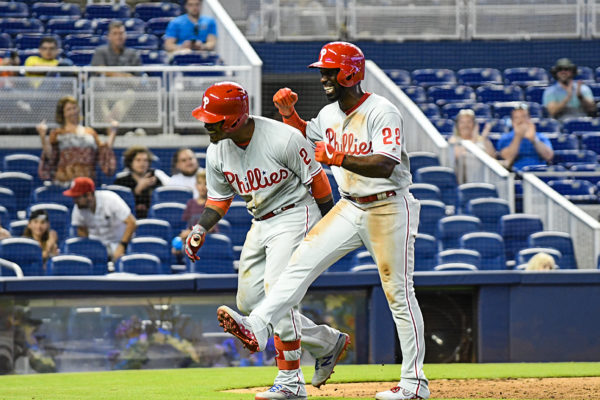 Philadelphia Phillies center fielder Andrew McCutchen (22) is all smiles after greeting Philadelphia Phillies shortstop Jean Segura (2)