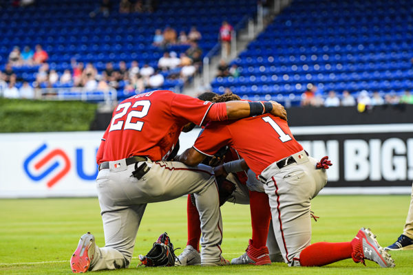 Washington Nationals players kneel for a prayer before the game