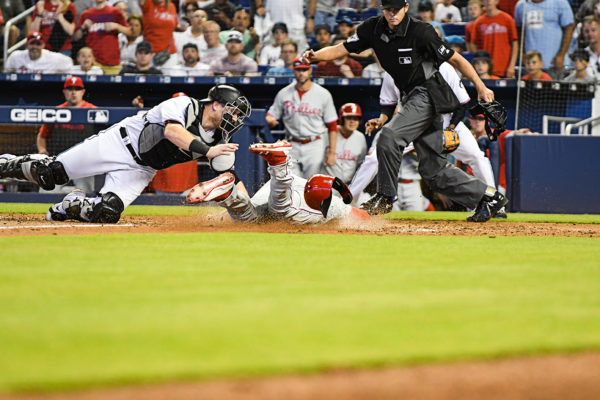 Philadelphia Phillies right fielder Bryce Harper (3) is tagged out at home by Miami Marlins catcher Chad Wallach (17)