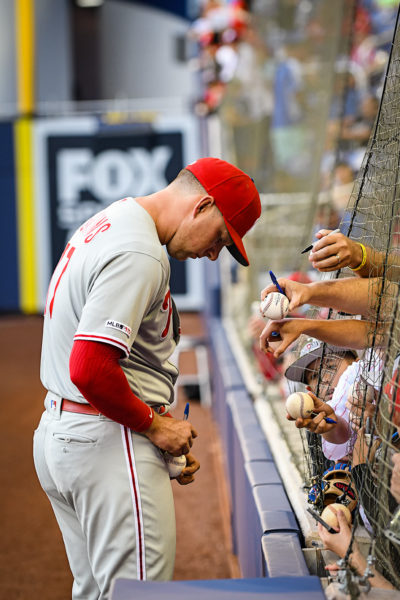 Philadelphia Phillies left fielder Rhys Hoskins (17) signs autographs for fans