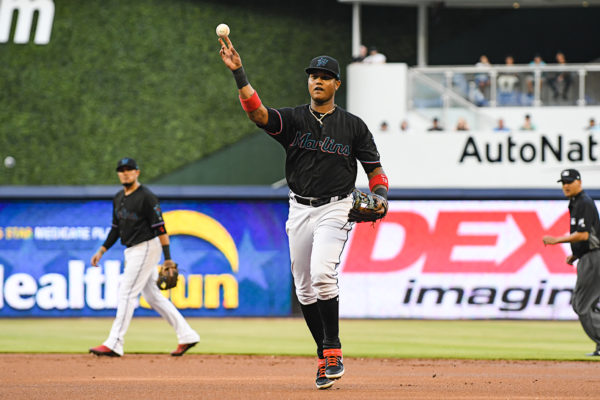 Miami Marlins second baseman Starlin Castro (13) throws the ball to first base