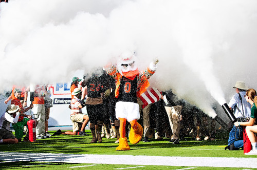 Sebastian the Ibis walks the team out through the smoke