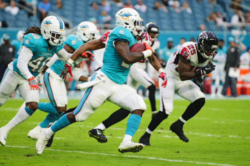 Dolphins KR, #27 Storm Johnson, runs a kickoff back against the Falcons