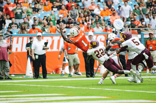 Mark Walton leaps for a touchdown