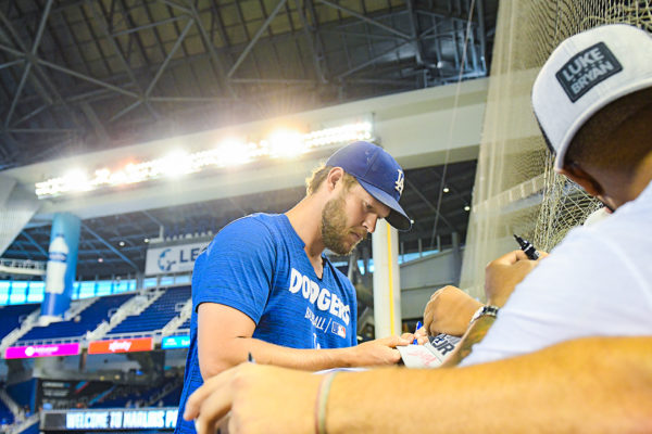 Los Angeles Dodgers starting pitcher Clayton Kershaw signs autographs