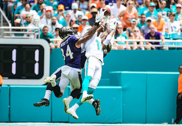 Miami Dolphins wide receiver DeVante Parker (11) hauls in a pass between 2 defenders | Baltimore Ravens vs. Miami Dolphins | September 8, 2019 | Hard Rock Stadium